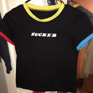red, blue, yellow, and all black tee